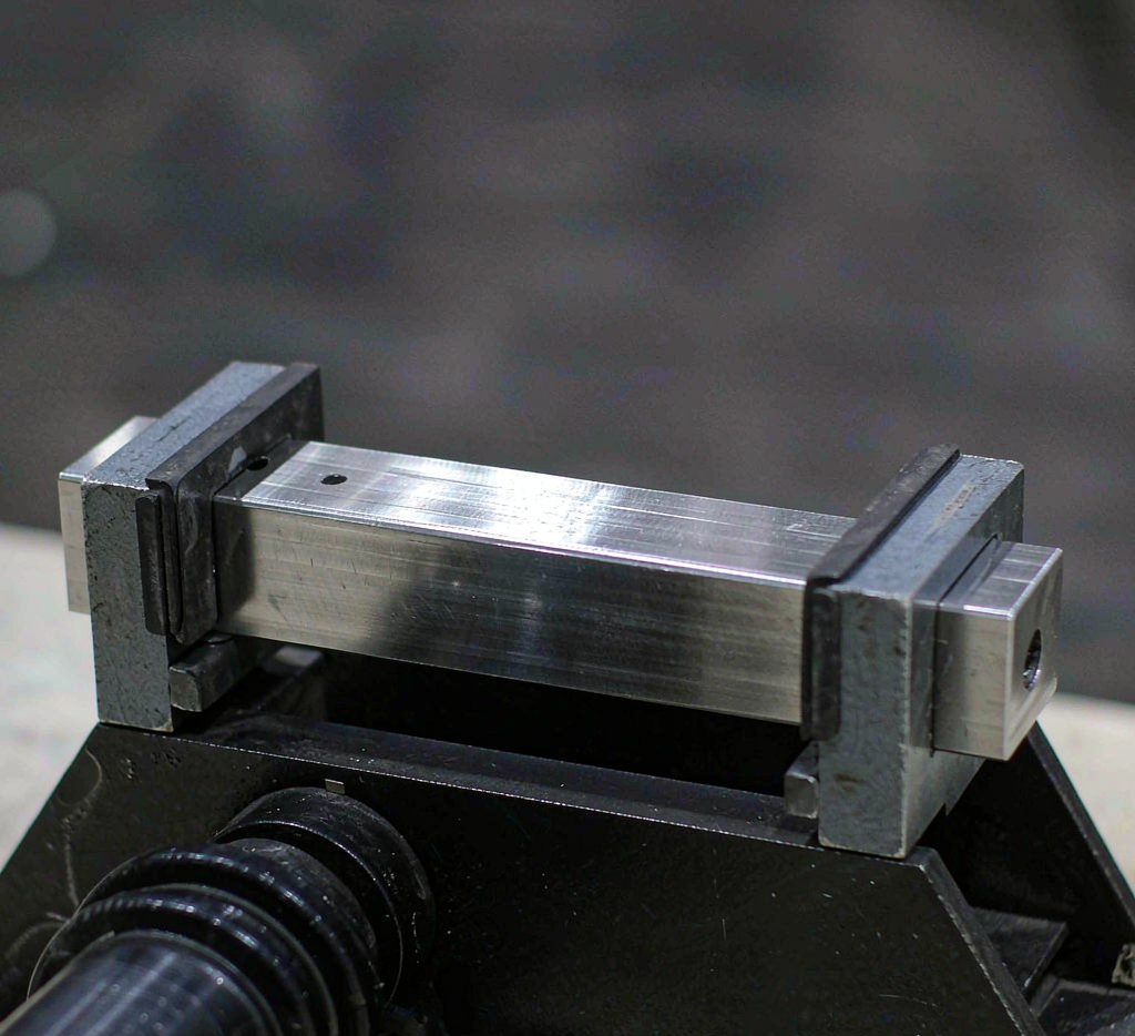 Carbon steel square bar cross-section showing sharp corners and uniform dimensions
