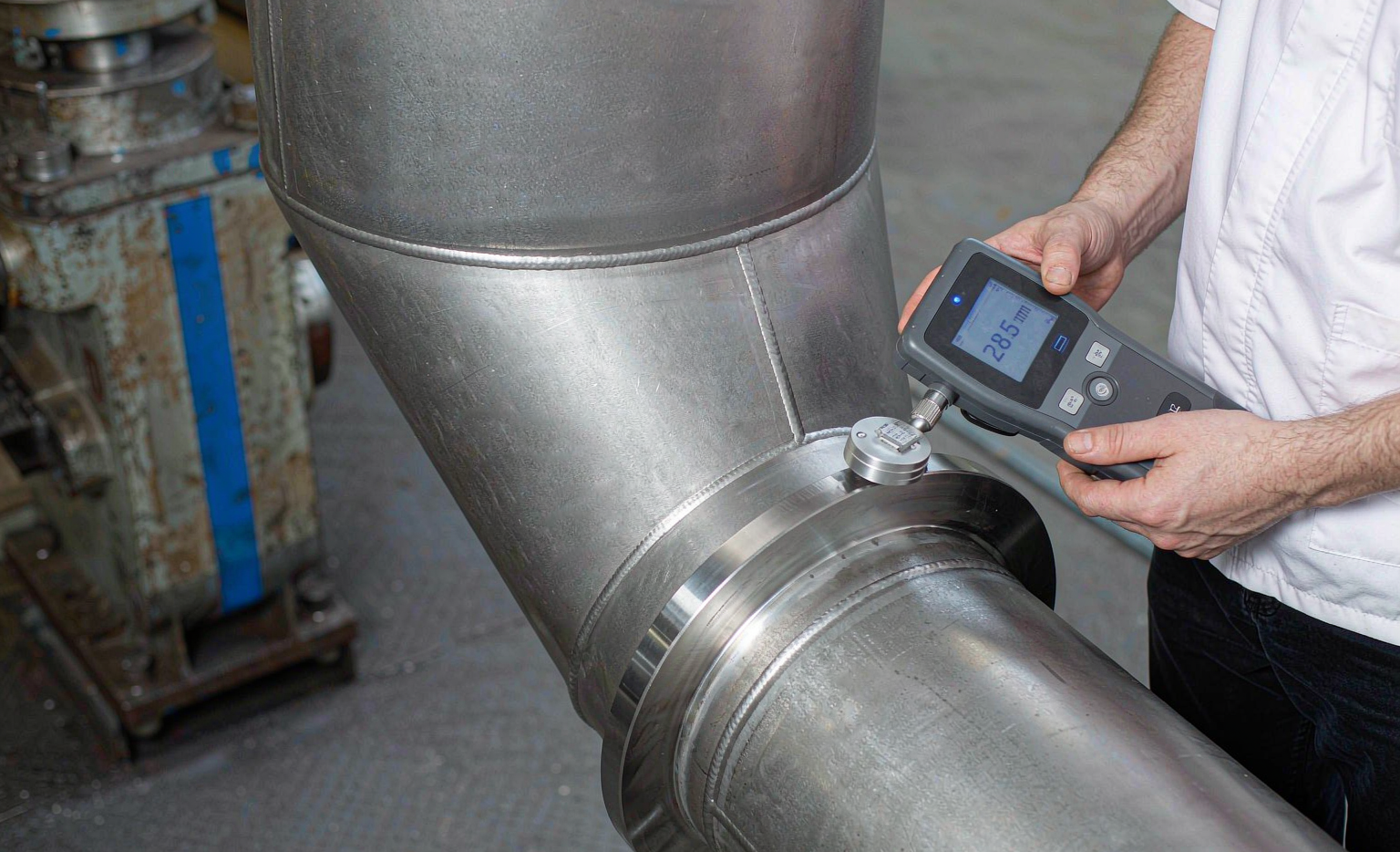 Engineer measuring pipe bevel angle and root face with gauge