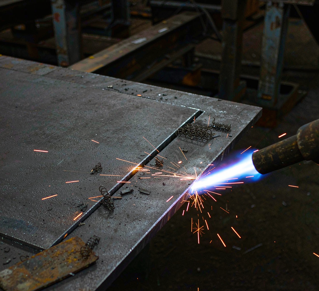 S50C carbon steel plate being flame cut to size with torch