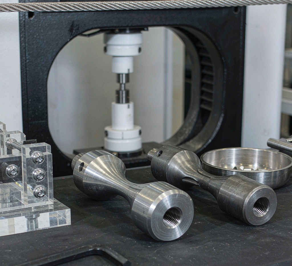 Tensile test specimens of 1020 and 1045 steel in a materials testing laboratory