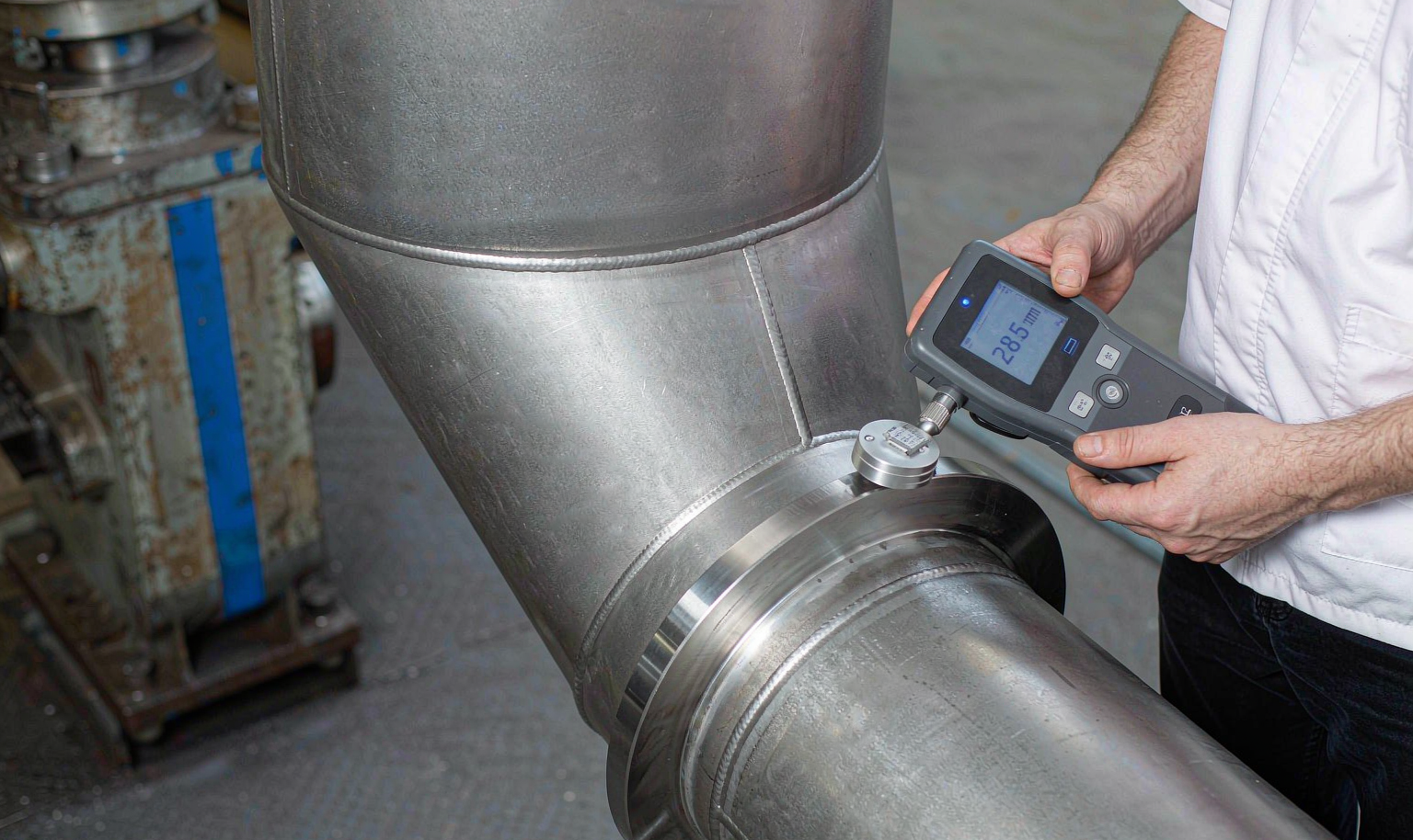 Inspector measuring a butt weld reducer against B16.9 tolerances